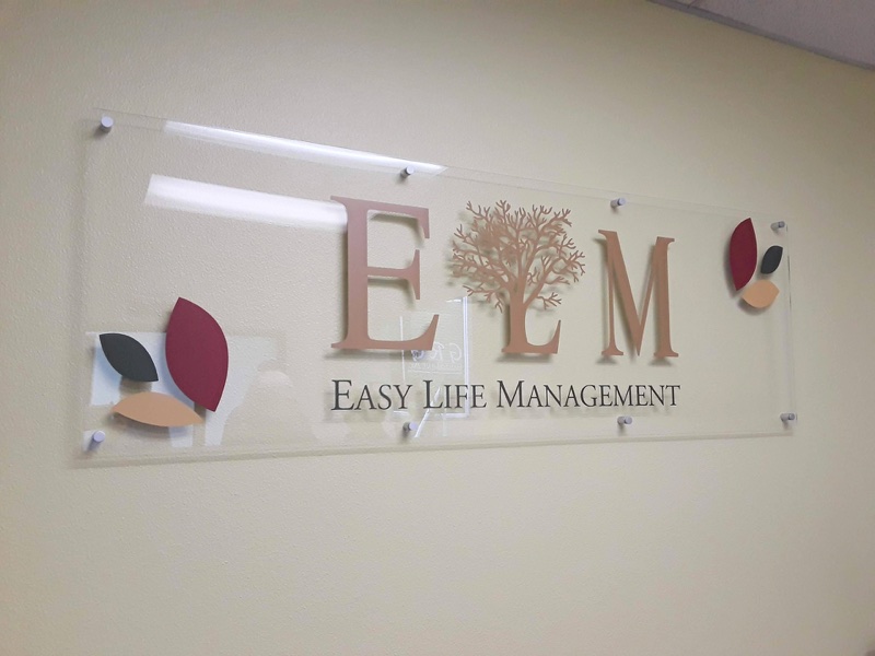 Easy Life Management logo sign on an office wall